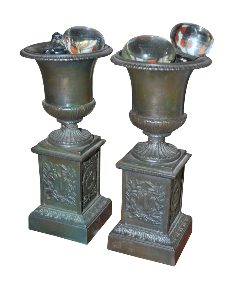 A Pair of Bronze Urns.