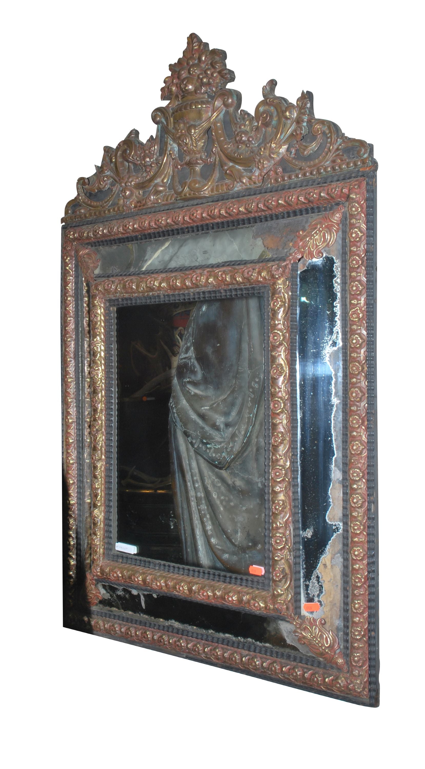 A Flemish Brass and Ebonised Cushion Front Mirror.