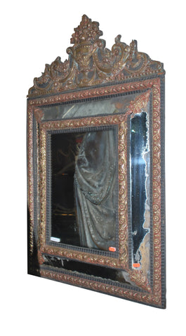 A Flemish Brass and Ebonised Cushion Front Mirror.