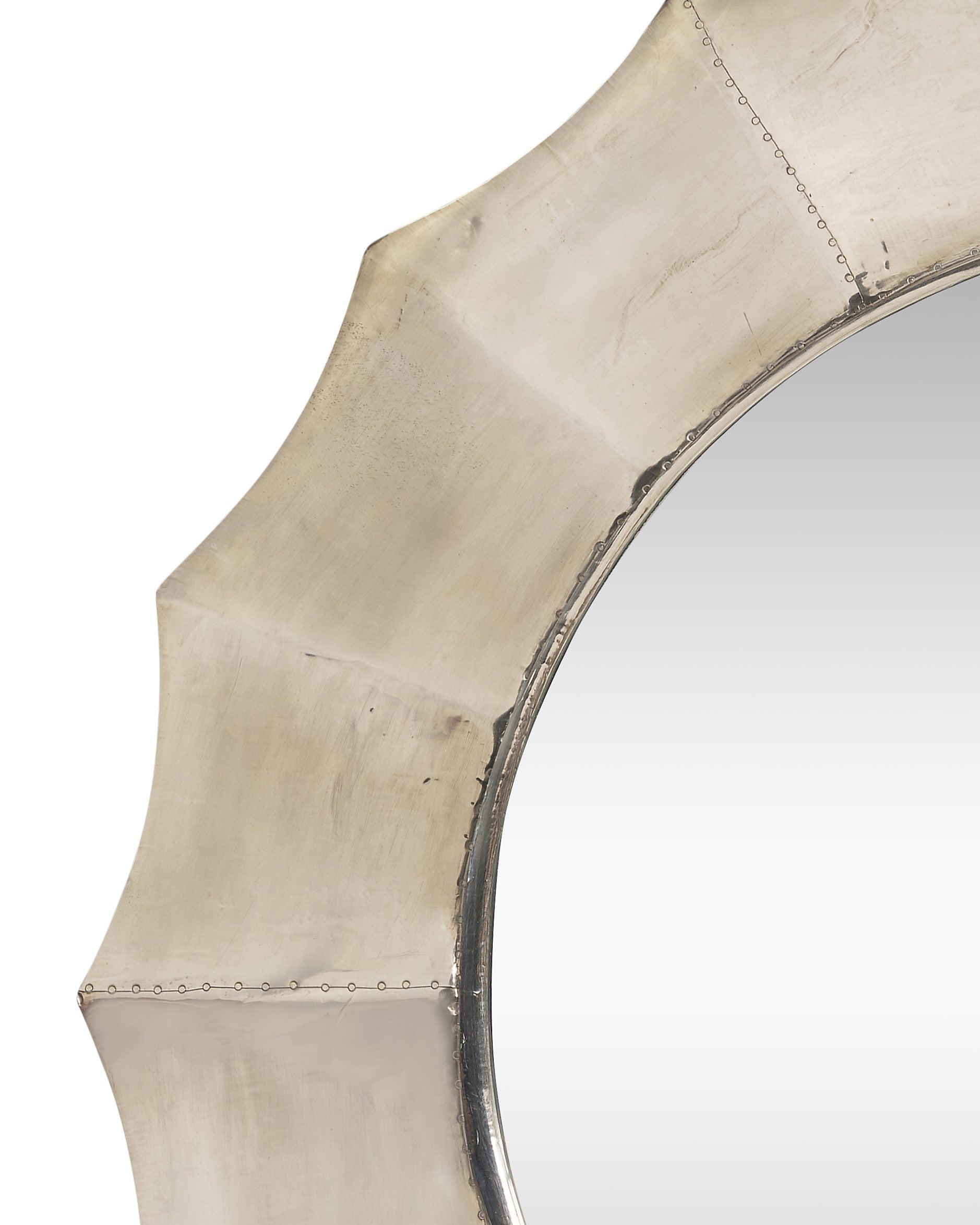 A Sunburst Mirror with Pressed Metal Overlay