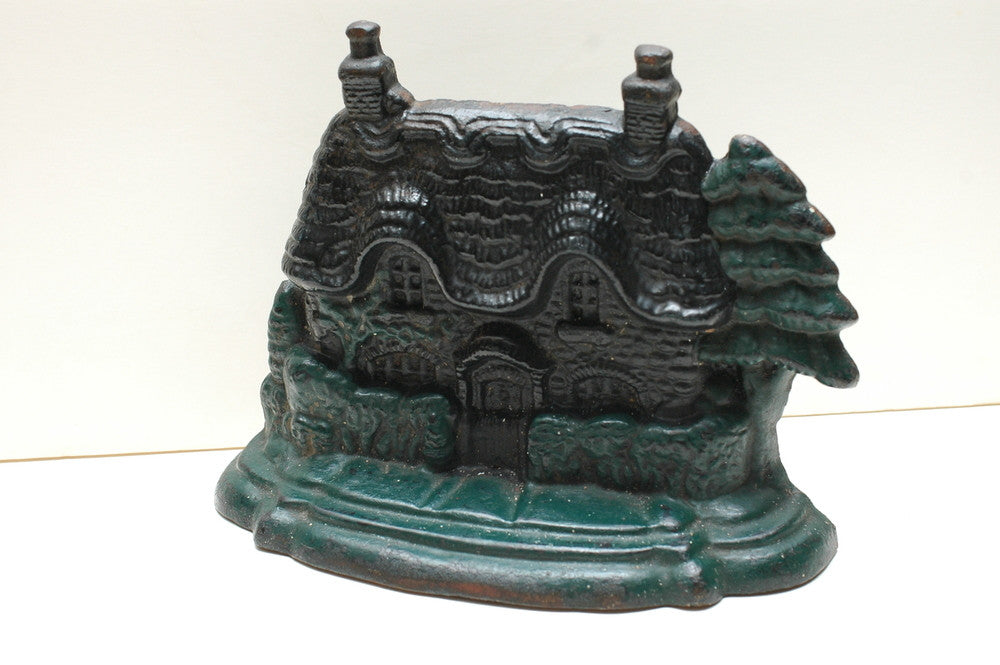 A Cast Iron Gingerbread House Door Stopper