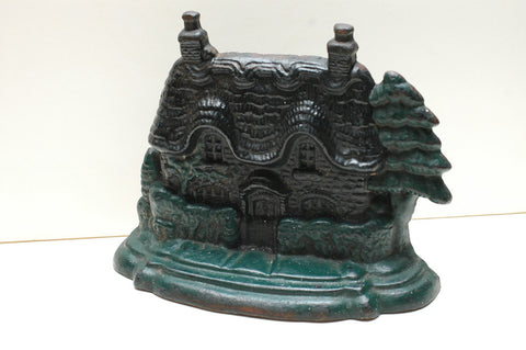 A Cast Iron Gingerbread House Door Stopper