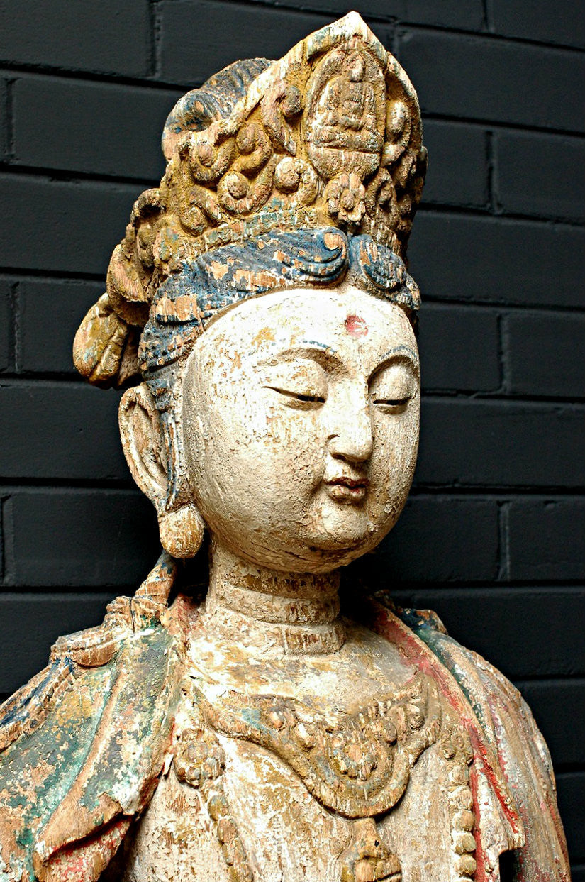 A Carved Wooden Figure of Guanyin Riding a Lion, Late Ming/early Qing period