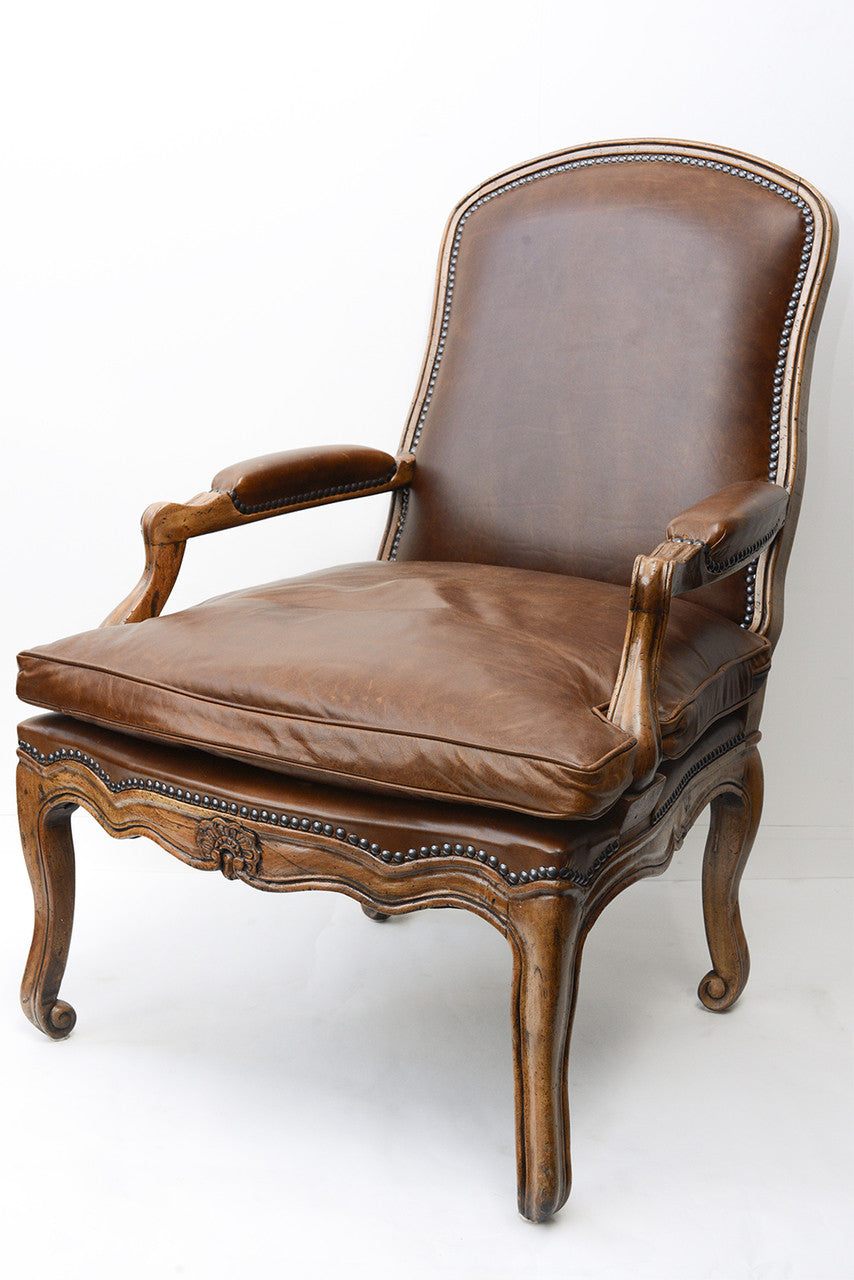 A Pair of French Leather Upholstered Walnut Framed Fauteuils
