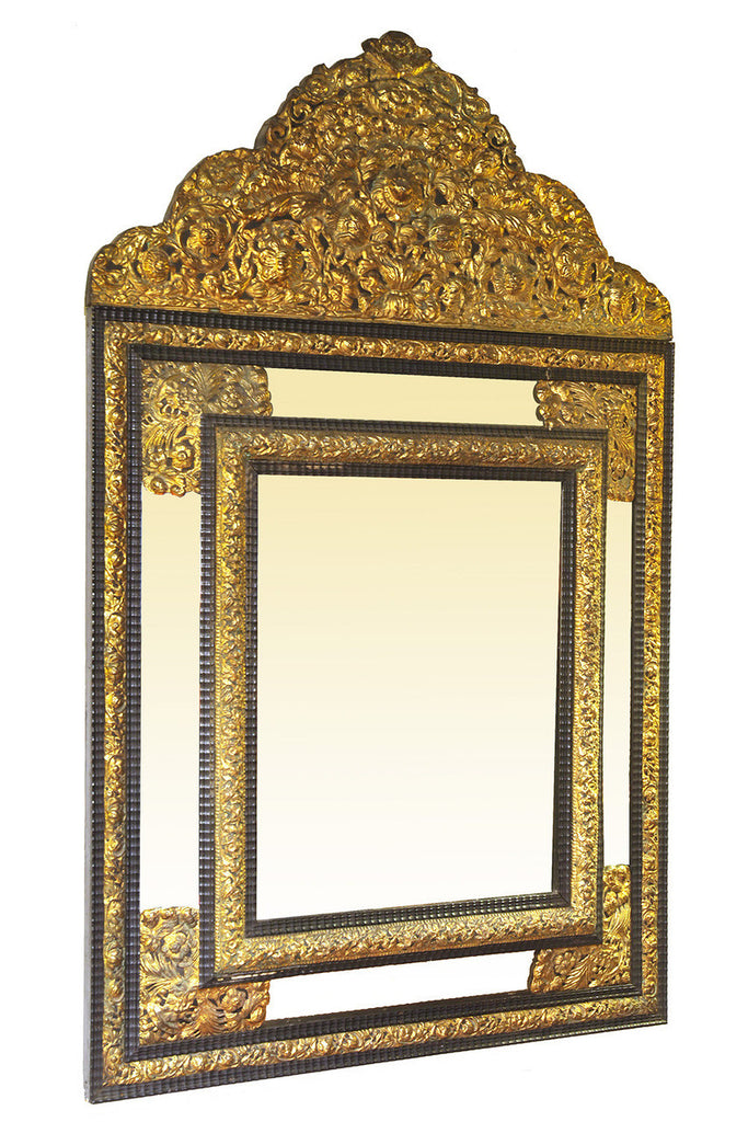 A French Embossed Brass Mounted Cushion Front Mirror.