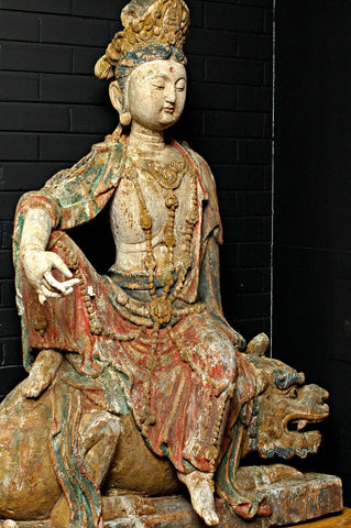 A Carved Wooden Figure of Guanyin Riding a Lion, Late Ming/early Qing period