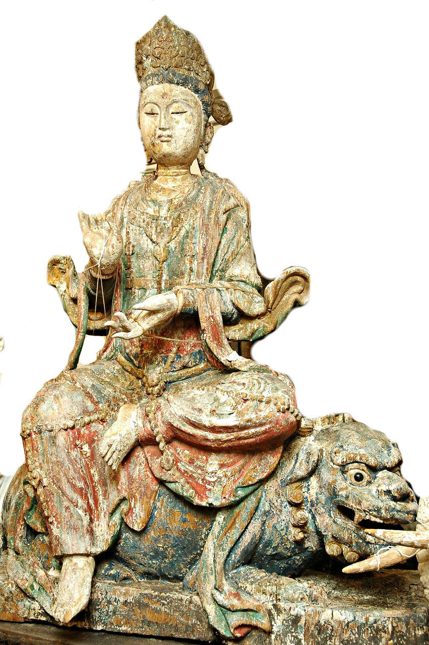 A Chinese Carved Wood Figure of Guanyin Riding a Lion, Late Ming/Early Qing Dynasty
