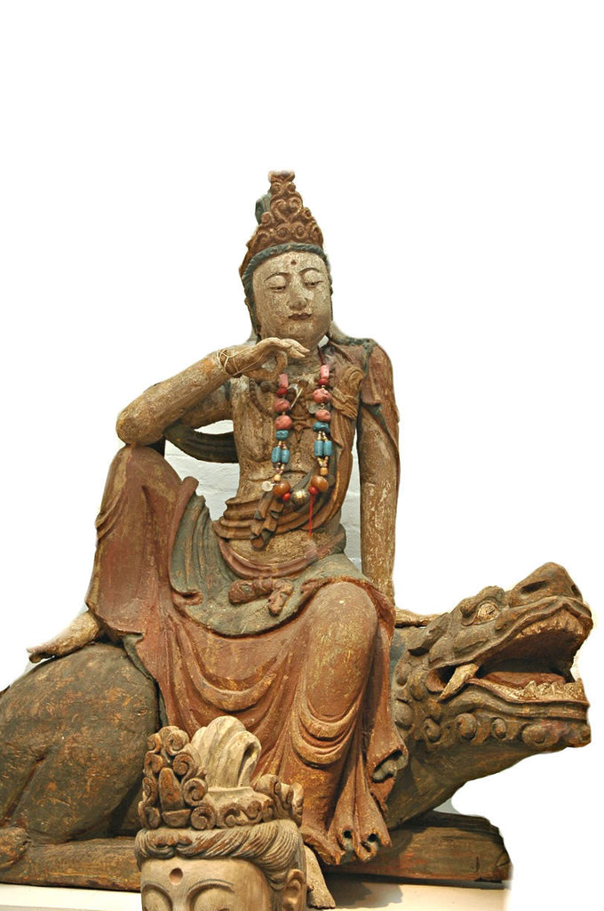 A Chinese Carved Wood Figure of Guanyin Riding a Lion, Ming Dynasty (1368-1644)