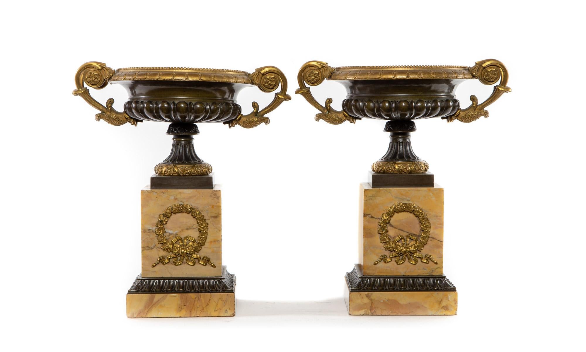 A Pair of Neoclassical Bronze and Gilt Bronze Urns on Sienna Marble Base